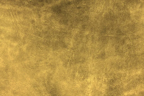 Deri dokuya sahip güzel altın arkaplan. Altın deri damarlar. Doğal deriden altın arkaplan örneği.
