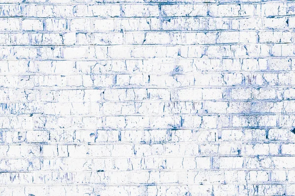 Brick wall with unusual white bricks made of whole white bricks and broken white bricks for an abstract white background