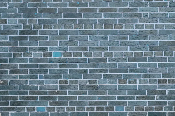Brick wall with unusual blue bricks made of whole blue bricks and broken blue bricks for an abstract blue background