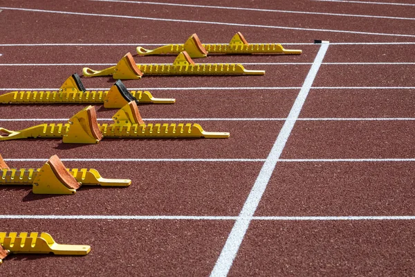 starting blocks and start line on a track in stadium