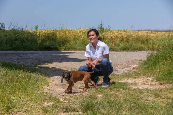 woman with cute sniffer dog puppy outdoors