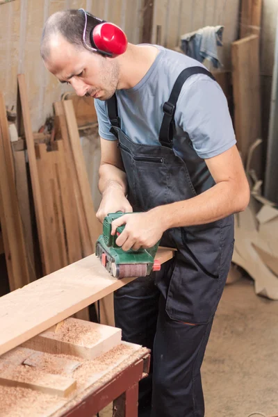 Carpenter with power grinder — Stock Photo, Image