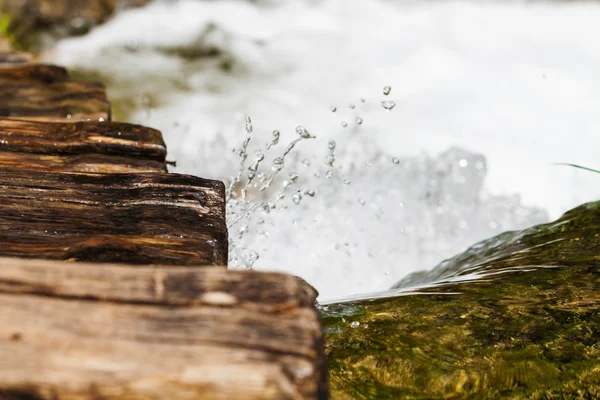 Wet wooden stairs with whitewater splash — Stock Photo, Image