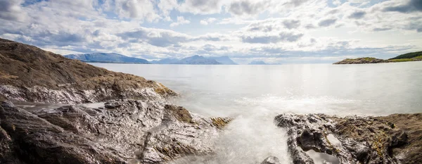 Panoramic long exposure shot of the sea with rocks in Northern N — Stock Photo, Image