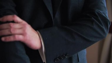 Genç bir adam içeride smokin giydi.