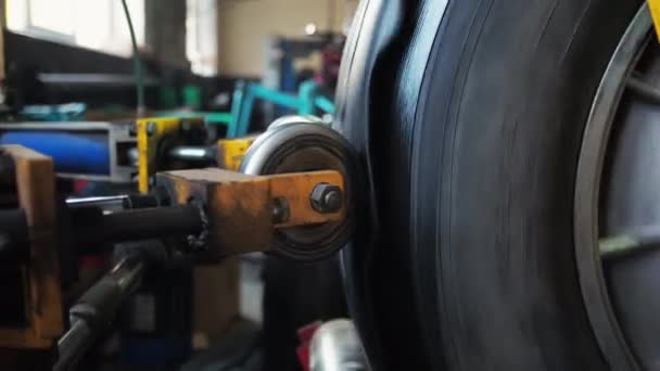 Hombre repara un neumático de un camión Reemplaza el recubrimiento y pegamentos con una máquina finaliza — Vídeos de Stock