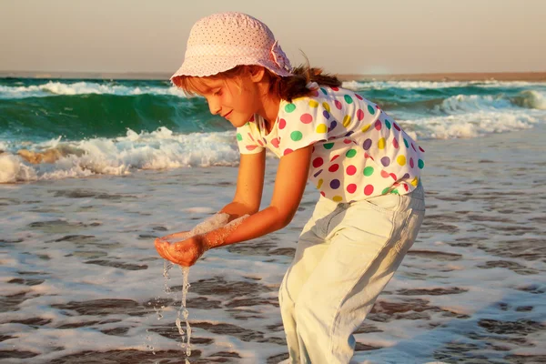 Szczęśliwy aktywne dziecko przelewanie i gra w morze. — Zdjęcie stockowe