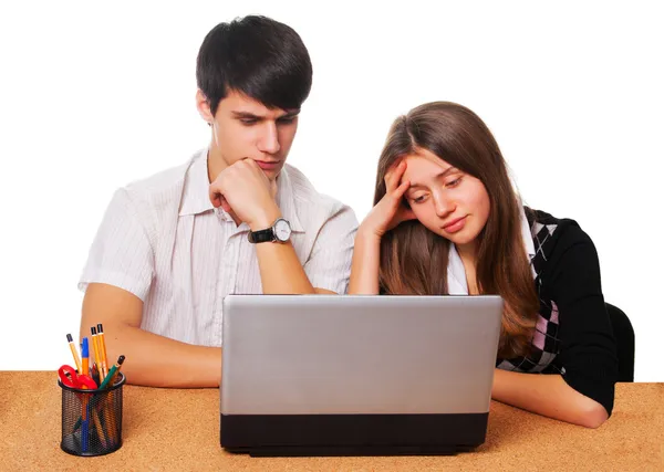 Tired young students studying  isolated over white — Stock Photo, Image