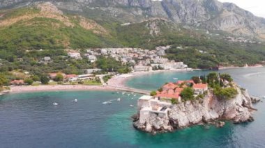 Karadağ 'ın küçük eski Sveti Stefan ve tatil beldesi Petrovac' ın insansız hava aracı videosu.