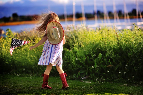 Little girl waving American flag Royalty Free Stock Images