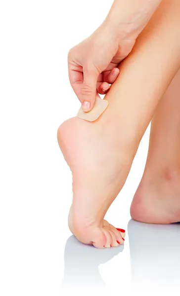 Band-aid on blister on leg — Stock Photo, Image