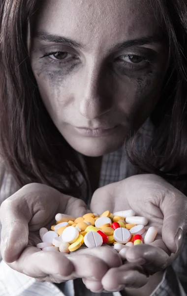 Woman with pills Stock Image