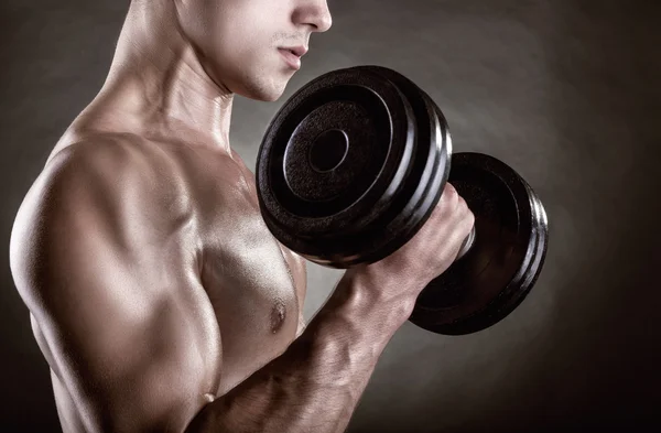Muscular man with dumbbells Stock Picture