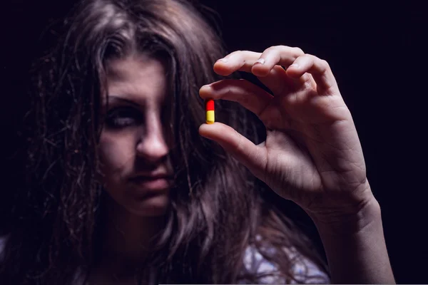 Woman holding pills Royalty Free Stock Images