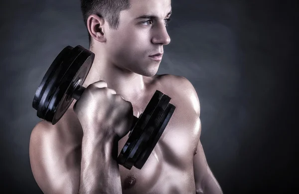 Muscular man with dumbbells — Stock Photo, Image