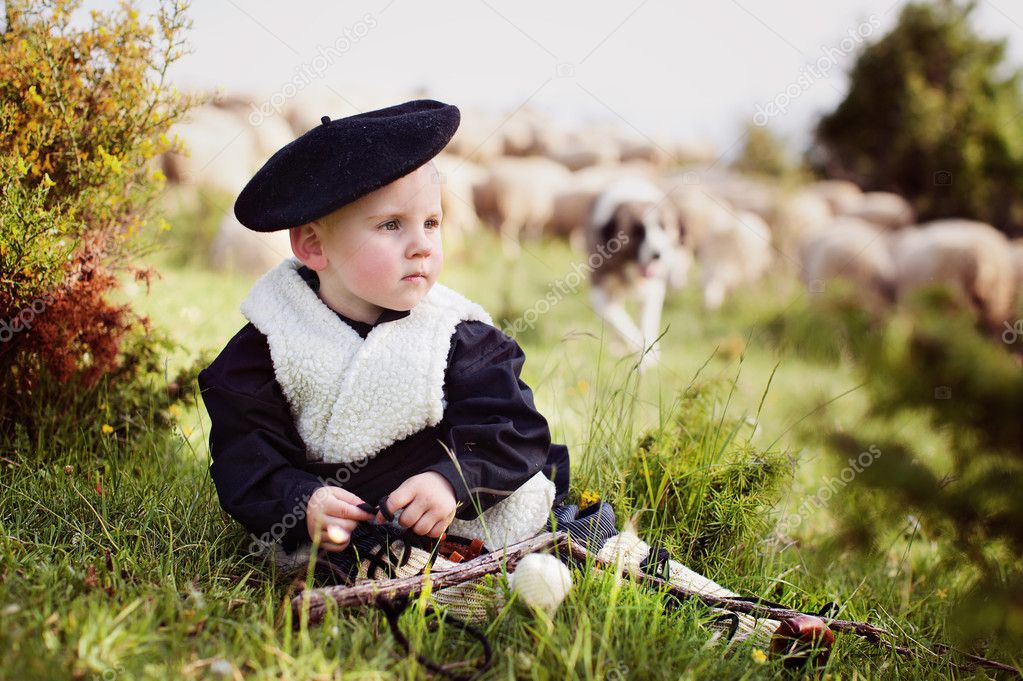 Niño en traje nacional con las ovejas
