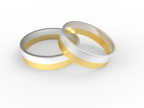 Золотые и серебряные обручальные кольца на белом фоне — стоковое фото
