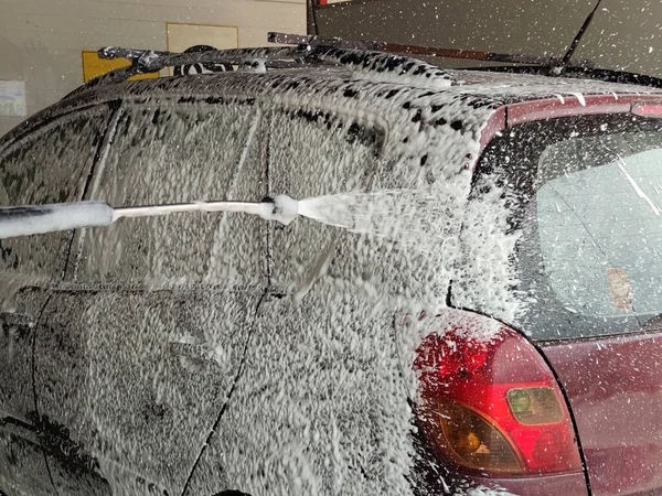 car wash, foam jet covers the car.