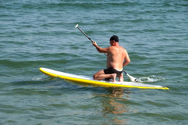 Man Oar Kneeling Sup Board Sea — Stock Photo, Image