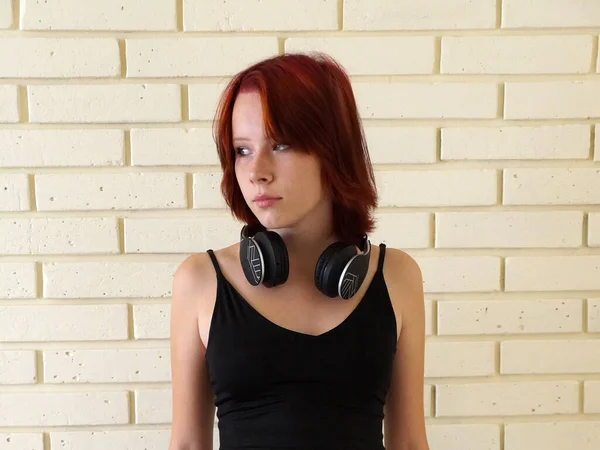 Portrait Red Haired Teenage Girl Headphones Her Neck Brick Wall — ストック写真