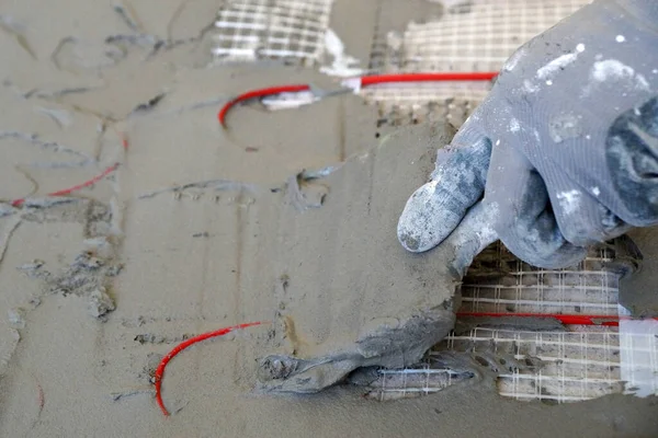 Worker Applies Cement Mortar Electric Cable Underfloor Heating Spatula Close — Fotografia de Stock