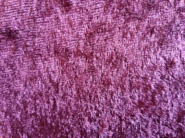 purple texture of plush velvet material for textile background close-up