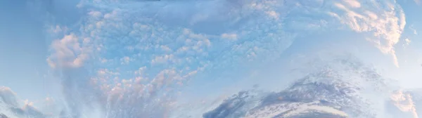 horizontal blue sky panorama with pink clouds for atmospheric background.