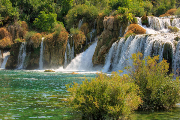 View of waterfall cascade on a sunny day in Krka National Park, Croatia