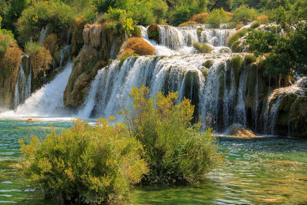 View of waterfall cascade on a sunny day in Krka National Park, Croatia