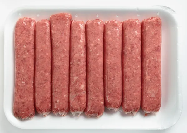 Beef sausages on a polystyrene tray — Stock Photo, Image