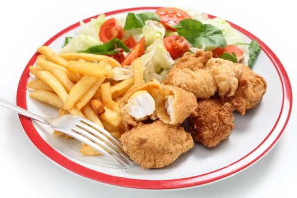 Fish nuggets fries, salad and fork — Stock Photo, Image