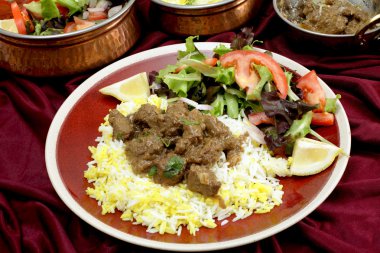Beef rogan josh dinner with bowls clipart