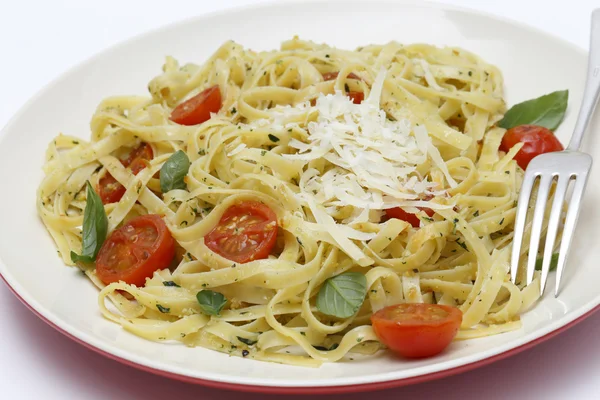 Tagliatelle with pesto tomatoes and fork — Stock Photo, Image