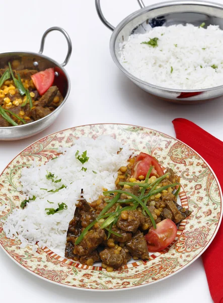 Lamb curry with split peas and serving bowls — Stock Photo, Image
