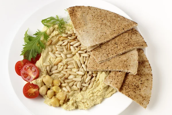 Lebanese hummus and pine nuts from above — Stock Photo, Image