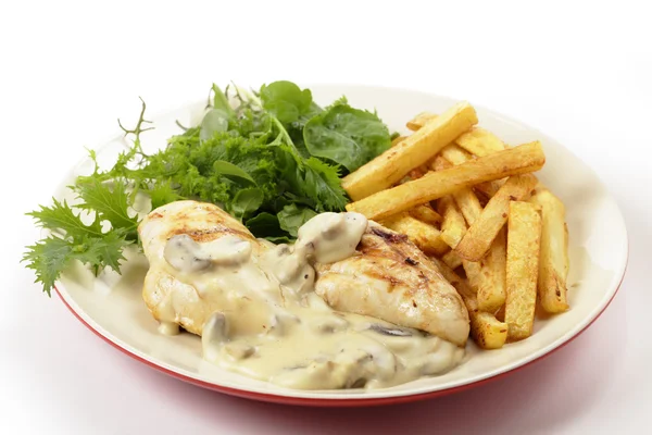 Chicken with mushroom sauce and salad side view — Stock Photo, Image