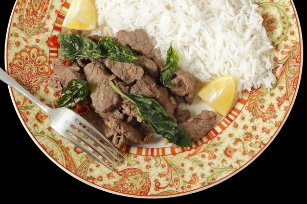 Chilli beef with basil over black — Stock Photo, Image