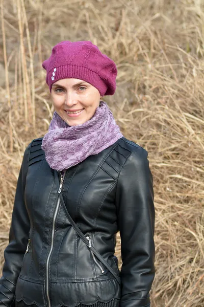 Woman in pink beret and black leather jacket