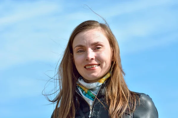 Portrait of a woman on the sky background — Stock Photo, Image