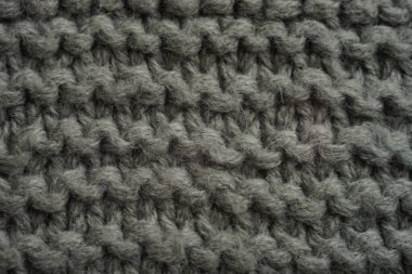 Dark grey knitted background, thread pattern.