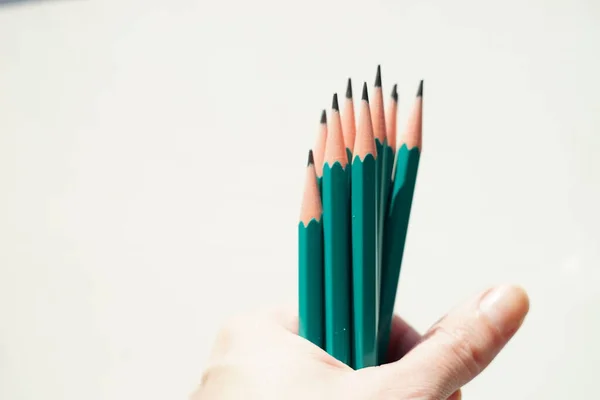 Green Set Graphite Pencils Hand White Wall Background — Stock Photo, Image