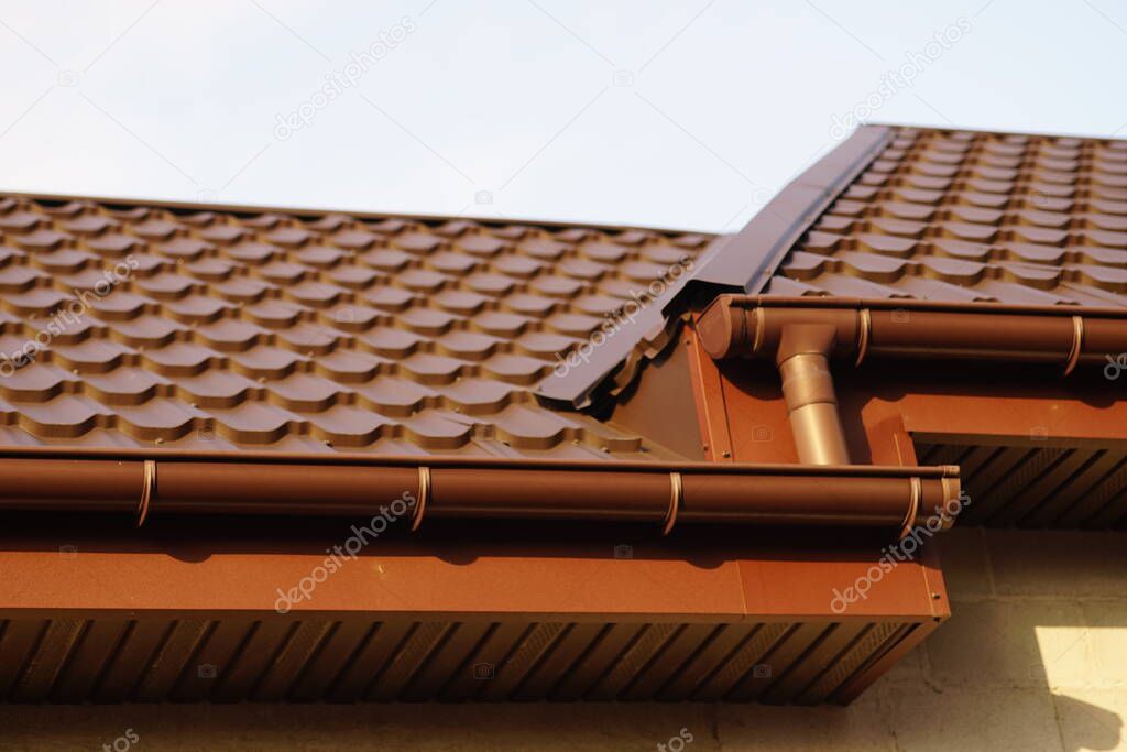 Close-up of modern brown tiled roof in sunny day.