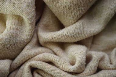 Örülmüş kremsi arka plan, bej süveter kaplama desen.