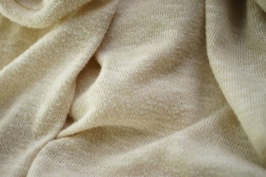 Matte cream yumuşak kumaş arka planı. Örülmüş kremsi kumaş desenli.
