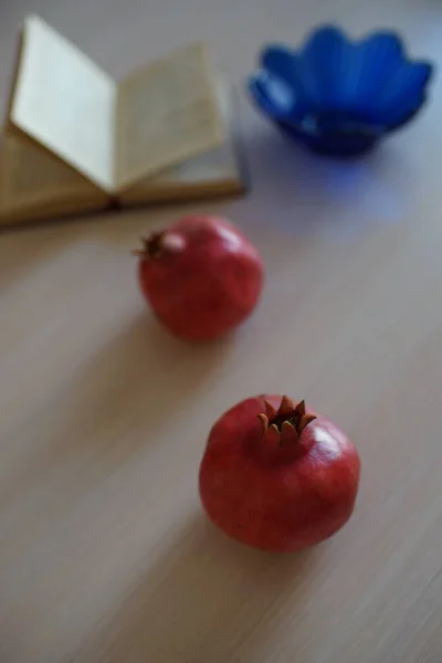 Zwei Ganze Reife Granatäpfel Ein Offenes Rezeptbuch Und Eine Blaue — Stockfoto