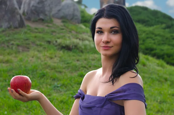 Glamorous woman holding a red apple — Stock Photo, Image