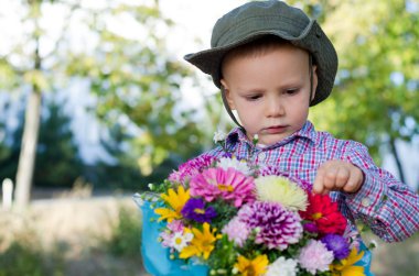 Cute little boy with bunch of flowers clipart