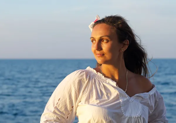 Mujer de pie con su espalda al mar — Foto de Stock