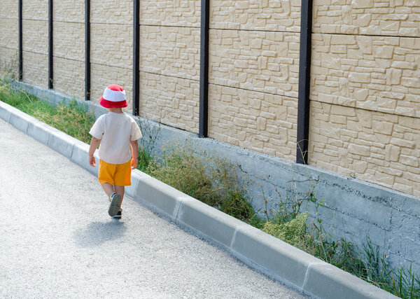 Little boy walking away