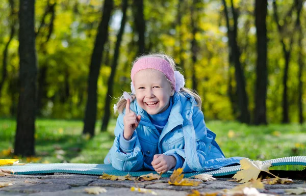 Glad liten tjej i en park på hösten — Stockfoto